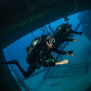 two divers penetrating a wreck